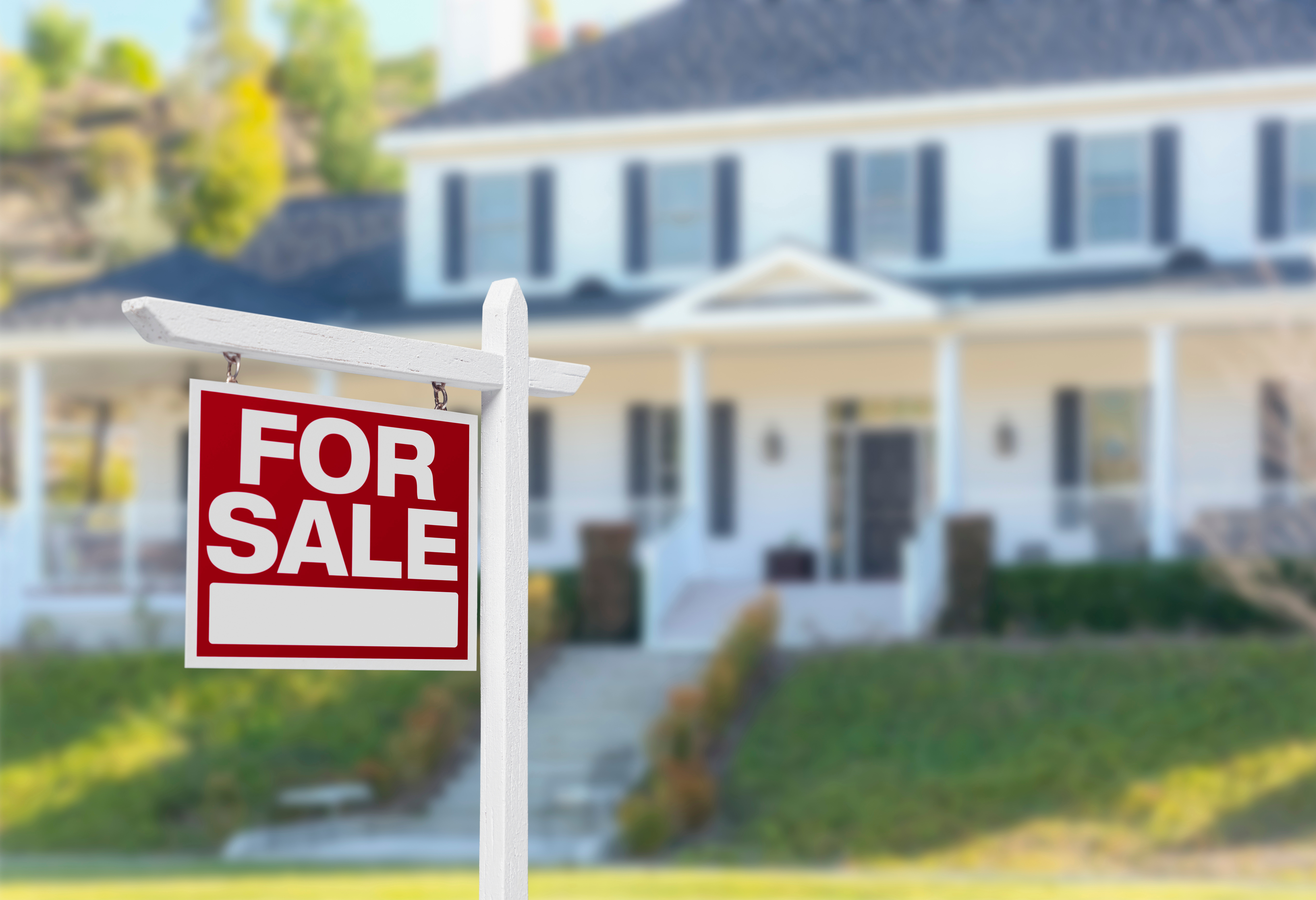 A home with a sign in front that says for sale